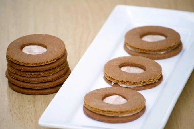 These Cream-Filled Molasses Cookies are a tasty gingerbread sandwich cookie with a cinnamon cream filling in the middle. They're great with a glass of milk!