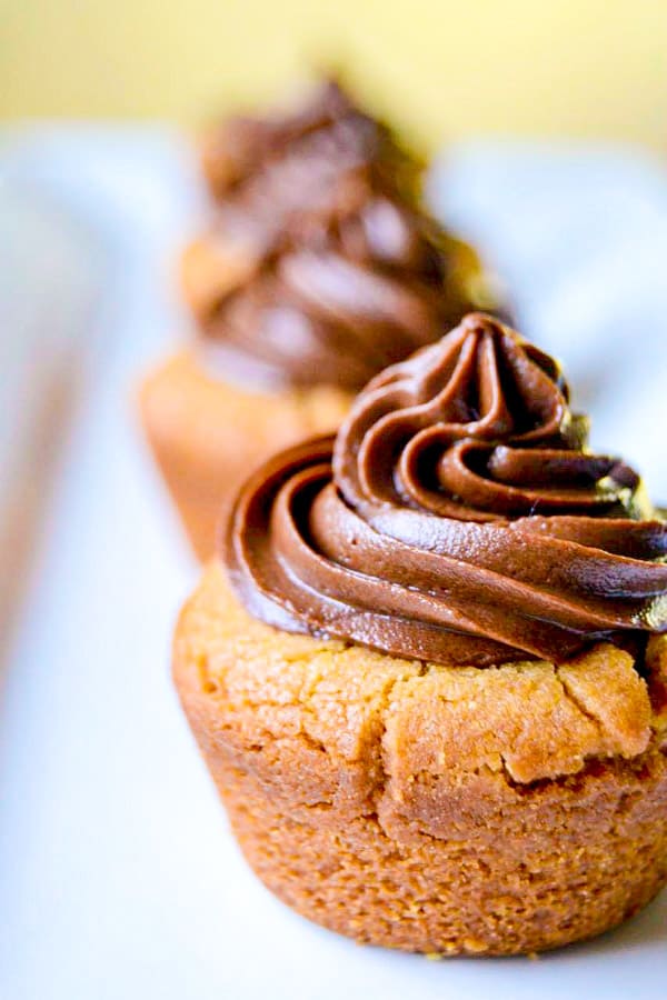 Peanut butter cookie cups stuffed with mini Reese's and topped with chocolate buttercream.