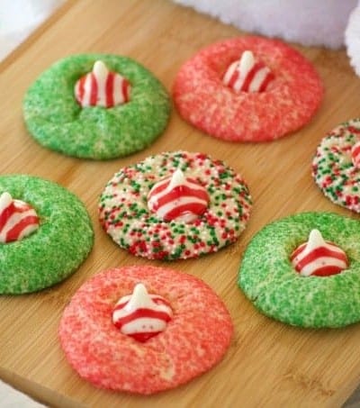 These Peppermint Blossom Cookies are a simple peppermint sugar cookie rolled in colored sugar and mulit-colored nonpareils with a Hershey's Peppermint Kiss.