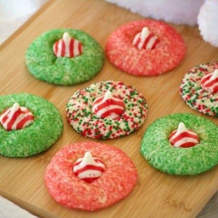 These Peppermint Blossom Cookies are a simple peppermint sugar cookie rolled in colored sugar and mulit-colored nonpareils with a Hershey's Peppermint Kiss.