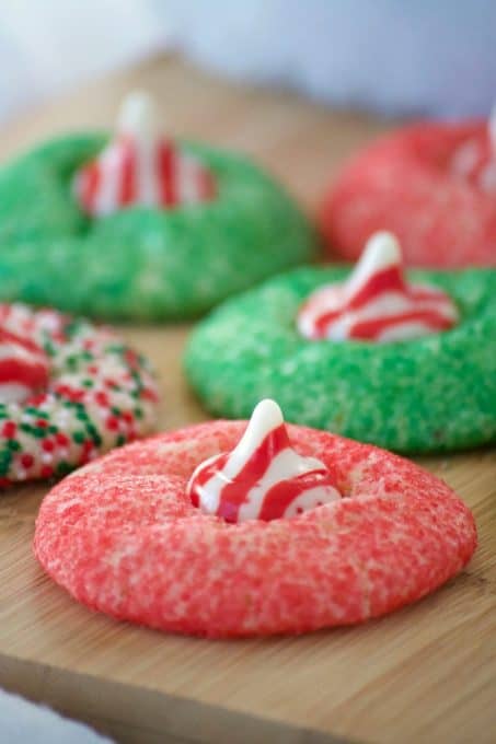 These Peppermint Blossom Cookies are a simple peppermint sugar cookie rolled in colored sugar and mulit-colored nonpareils with a Hershey's Peppermint Kiss.