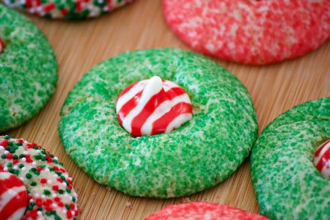 These Peppermint Blossom Cookies are a simple peppermint sugar cookie rolled in colored sugar and mulit-colored nonpareils with a Hershey's Peppermint Kiss.
