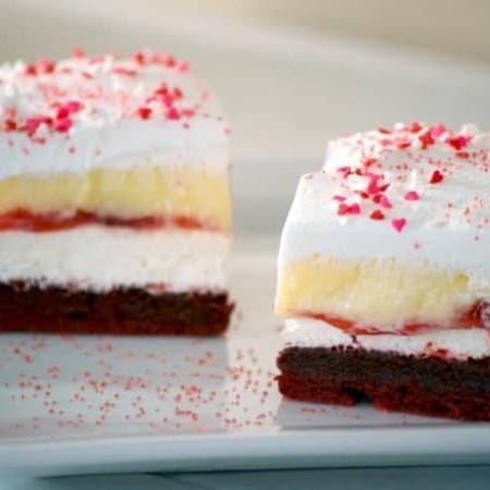 These Red Velvet Cherry Dream Bars with their red velvet cookie crust, sweet cheese layer, cherry pie filling, vanilla pudding and whipped topping make these bars the perfect holiday treat. Or better yet, enjoy them all year 'round.