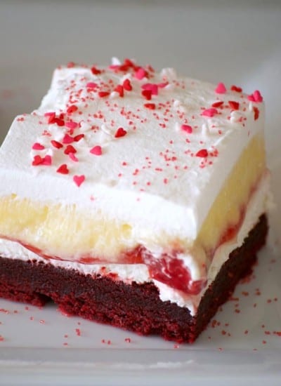 These Red Velvet Cherry Dream Bars with their red velvet cookie crust, sweet cheese layer, cherry pie filling, vanilla pudding and whipped topping make these bars the perfect holiday treat. Or better yet, enjoy them all year 'round.