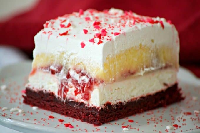 These Red Velvet Cherry Dream Bars with their red velvet cookie crust, sweet cheese layer, cherry pie filling, vanilla pudding and whipped topping make these bars the perfect holiday treat. Or better yet, enjoy them all year 'round.