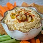 This Roasted Garlic Hummus is roasted cloves of garlic, tahini, lemon juice and spices. Served with pita chips or veggies, it's the perfect healthy treat. 