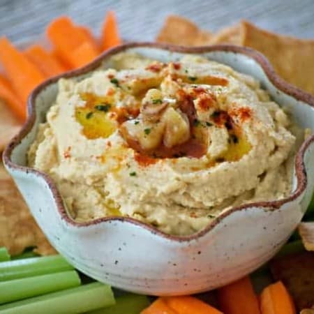 This Roasted Garlic Hummus is roasted cloves of garlic, tahini, lemon juice and spices. Served with pita chips or veggies, it's the perfect healthy treat.