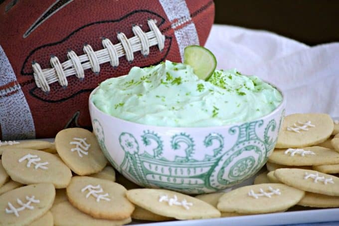 This Lime Cheesecake Dip made with cream cheese, confectioners' sugar, Shamrock Farms sour cream, lime juice and gelatin pairs perfectly with Football Sugar Cookies and some fresh fruit. It's the perfect Game Day treat and you'll be voted MVP!