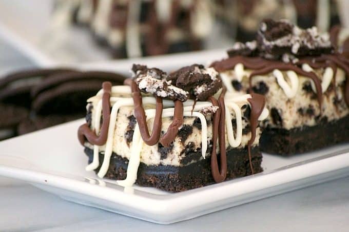 Everyone will love these Cookies and Cream Cheesecake Bars with their Oreo cookie crust, cookies and cream cheesecake layer and drizzled with chocolate.