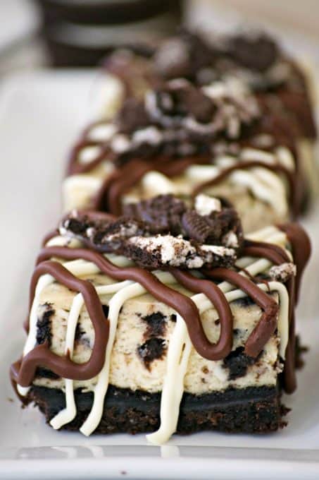Everyone will love these Cookies and Cream Cheesecake Bars with their Oreo cookie crust, cookies and cream cheesecake layer and drizzled with chocolate.