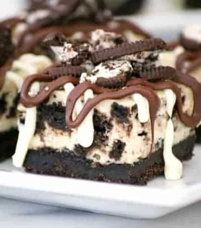 Everyone will love these Cookies and Cream Cheesecake Bars with their Oreo cookie crust, cookies and cream cheesecake layer and drizzled with chocolate.