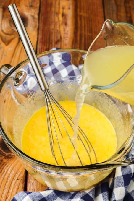 Pouring fresh lemon juice into curd.