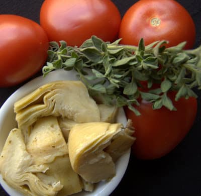 Fresh herbs, tomatoes, chicken, artichokes and cheese, make this Artichoke Tomato Chicken a super easy meal that is on the table in less than 30 minutes!