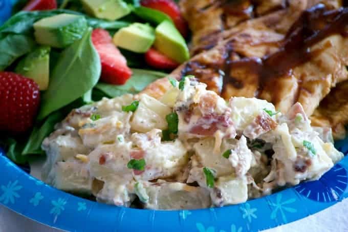 Our Loaded Red Bliss Potato Salad with all the fixin's - a dijon-mayo dressing, bacon, green onions and cheese is a potato salad you'll eat all summer long!