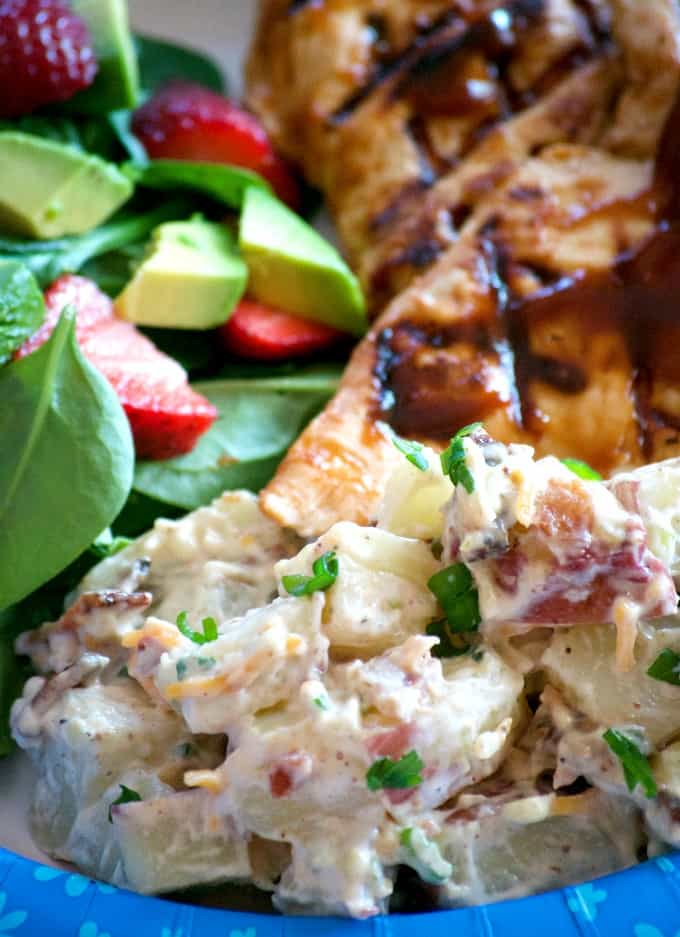 Our Loaded Red Bliss Potato Salad with all the fixin's - a dijon-mayo dressing, bacon, green onions and cheese is a potato salad you'll eat all summer long!