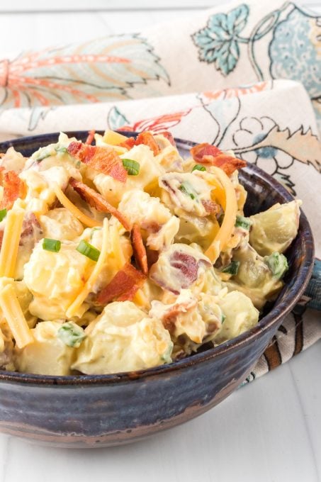 Loaded potato salad with bacon, cheese, and green onions.