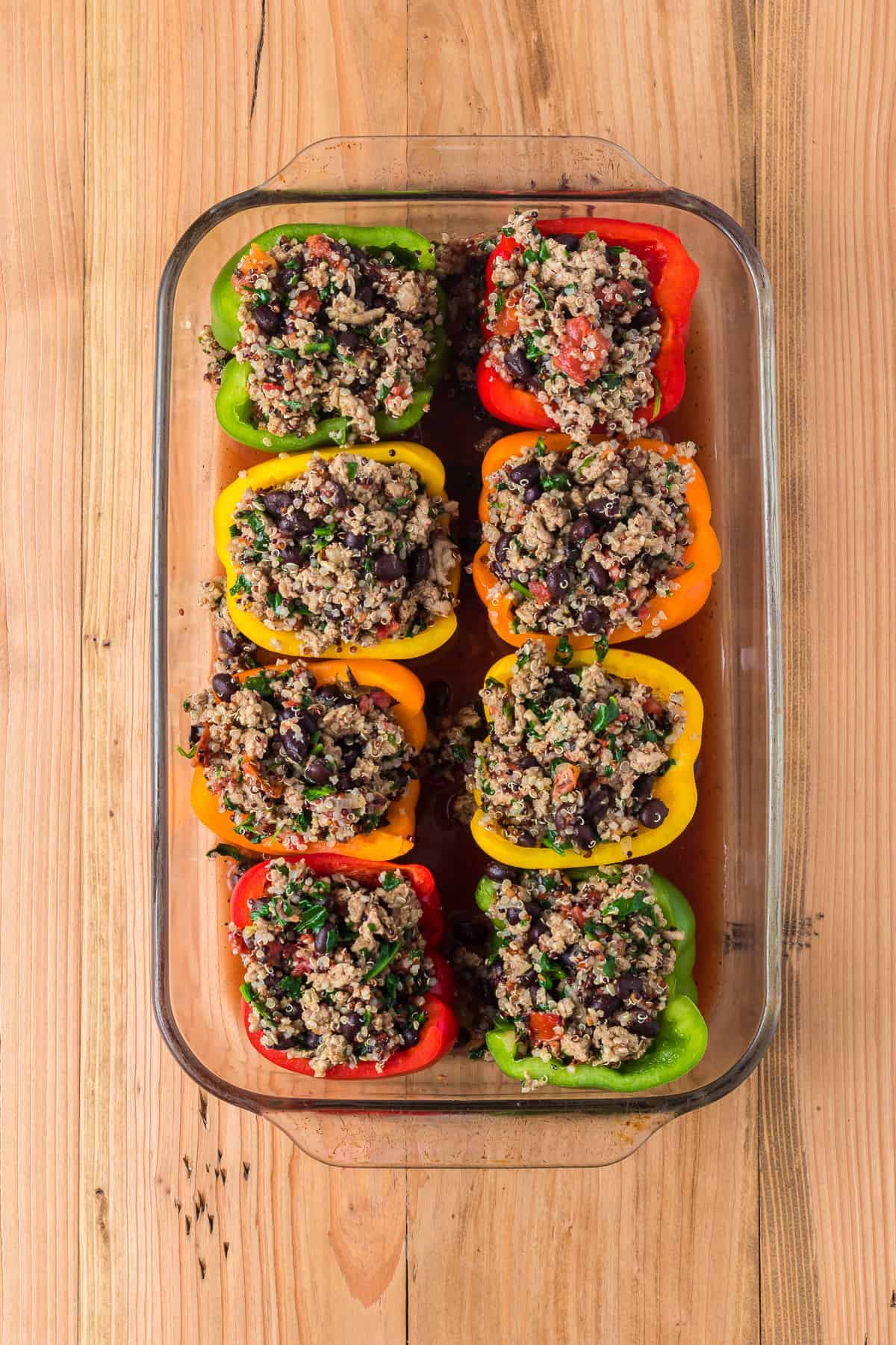 A baking dish filled with quinoa stuffed peppers
