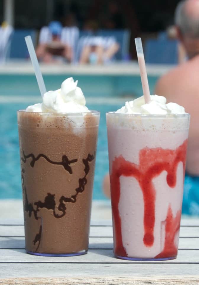 This Double Chocolate Malted Milkshake topped with whipped cream and a cherry is the perfect cold treat to satisfy a chocolate craving on a hot summer day.