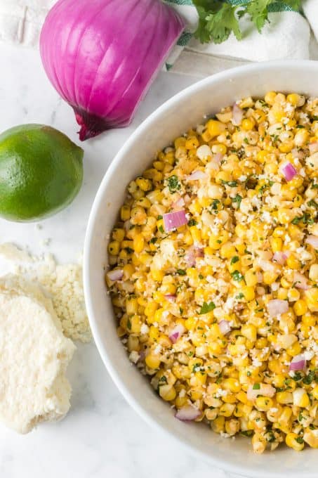 A side dish made with fresh corn, red onion, lime juice, chili powder and Cotija cheese.