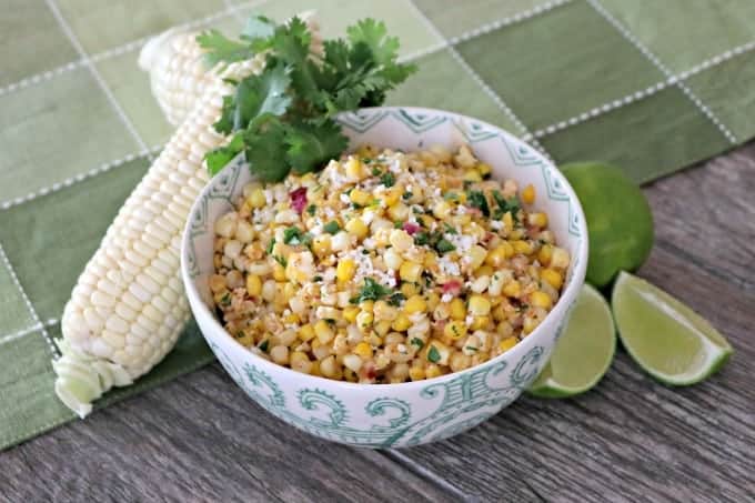 Corn, cilantro, cayenne, lime, Cotija cheese and more make this Skillet Mexican Street Corn from Mary Younkin's (Barefeet in the Kitchen) The Weeknight Dinner Cookbook an irresistible side dish.