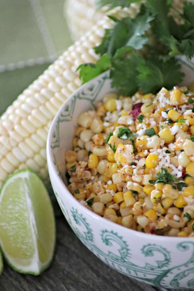 Corn, cilantro, cayenne, lime, Cotija cheese and more make this Skillet Mexican Street Corn from Mary Younkin's (Barefeet in the Kitchen) The Weeknight Dinner Cookbook an irresistible side dish.