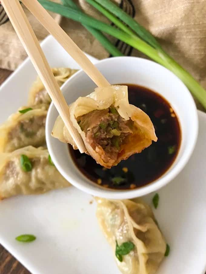 These easy Pork Potstickers with ground pork, ginger, garlic, cabbage and soy sauce wrapped in a light dough are perfect as an appetizer or main course!