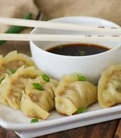 These easy Pork Potstickers with ground pork, ginger, garlic, cabbage and soy sauce wrapped in a light dough are perfect as an appetizer or main course!