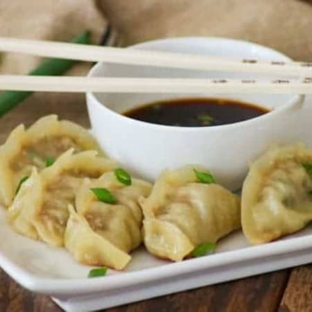 These easy Pork Potstickers with ground pork, ginger, garlic, cabbage and soy sauce wrapped in a light dough are perfect as an appetizer or main course!