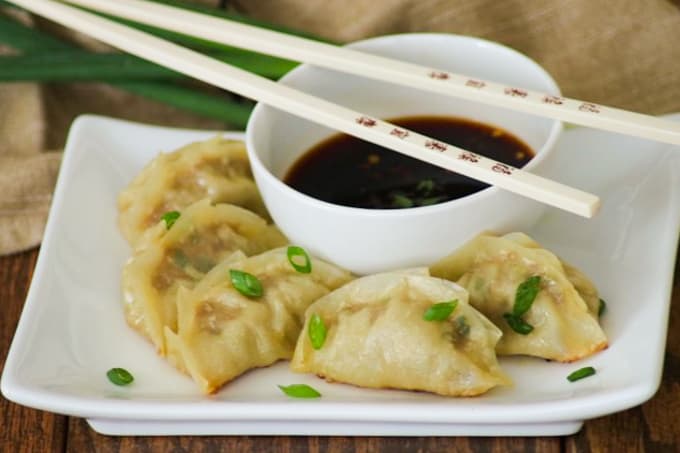 These easy Pork Potstickers with ground pork, ginger, garlic, cabbage and soy sauce wrapped in a light dough are perfect as an appetizer or main course!