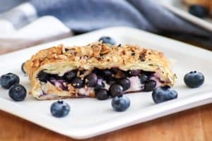 This Blueberry Ginger Cheese Danish is quickly going to become your new favorite breakfast treat! A slice of Puff Pastry with sweetened cream and blueberry ginger filling sprinkled with McCormick® Good Morning Blueberry Ginger Breakfast Toppers is hard to resist.