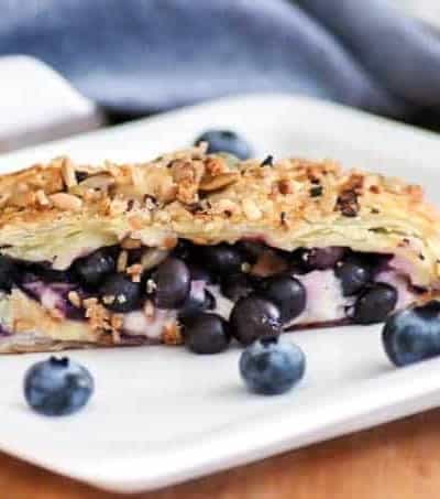 This Blueberry Ginger Cheese Danish is quickly going to become your new favorite breakfast treat! A slice of Puff Pastry with sweetened cream and blueberry ginger filling sprinkled with McCormick® Good Morning Blueberry Ginger Breakfast Toppers is hard to resist.