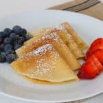 My family absolutely loves this Easy Crepe Recipe and yours will, too. Simply made with flour, eggs, milk and a little sugar, these thin French crepes or pancakes can be enjoyed a variety of ways. My favorite way to eat them is warmed with some pure maple syrup, but they're delicious with fillings, too!