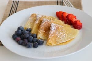 My family absolutely loves this Easy Crepe Recipe and yours will, too. Simply made with flour, eggs, milk and a little sugar, these thin French crepes or pancakes can be enjoyed a variety of ways. My favorite way to eat them is warmed with some pure maple syrup, but they're delicious with fillings, too!