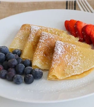 My family absolutely loves this Easy Crepe Recipe and yours will, too. Simply made with flour, eggs, milk and a little sugar, these thin French crepes or pancakes can be enjoyed a variety of ways. My favorite way to eat them is warmed with some pure maple syrup, but they're delicious with fillings, too!