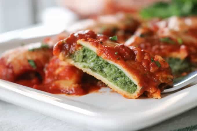 This easy Spinach and Cheese Manicotti is an old family favorite. It starts with a smooth, creamy filling made of cottage cheese, spinach, and eggs, and is rolled into a homemade crepe. Serve them with a salad and you have a delicious dinner that your family will enjoy for years to come.