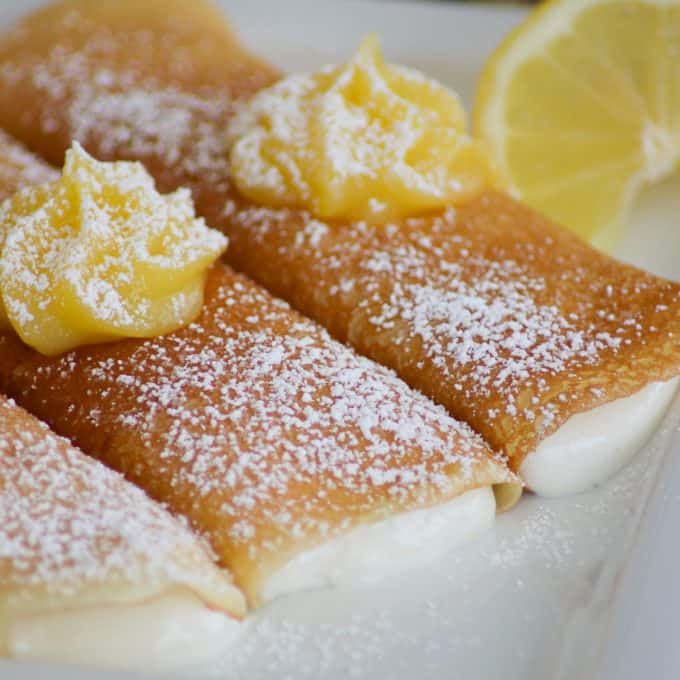 Lemon Crepes with a sweet, smooth filling with lemon curd on top.