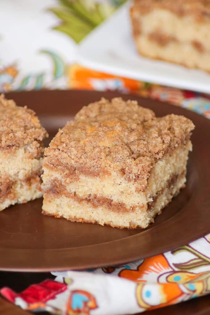 This Cinnamon Sour Cream Coffee Cake from Mary Younkin's new cookbook, The Weekday Lunches & Breakfasts Cookbook, is a recipe you'll make again and again. The cake is super moist and with a layer of cinnamon streusel both on the top and in the middle, this morning treat is hard to resist and it's perfect with coffee! Bet you can't resist the two layers of cinnamon streusel in this Cinnamon SourCream Coffee Cake!