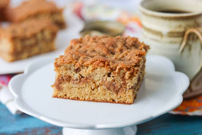 A slice of coffee cake on a small cake plate.