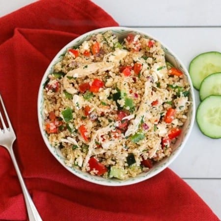 A bowl of Greek Quinoa Chicken Salad made of cooked chicken, bell peppers, feta cheese and quinoa. Easy and delicious doesn't get better than this!