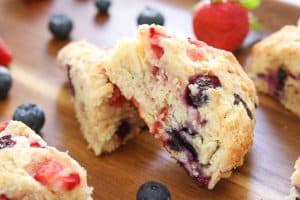 Delicious Mixed Berry Scones on a wooden tray made with Fair Trade Certified strawberries and blueberries.