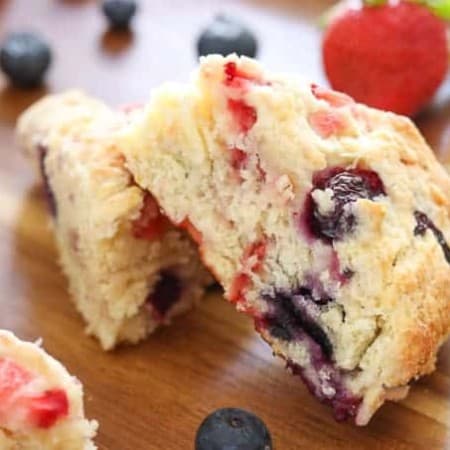 Delicious Mixed Berry Scones on a wooden tray made with Fair Trade Certified strawberries and blueberries.
