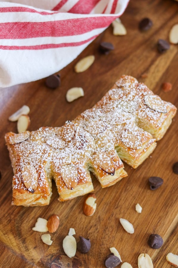 To make Chocolate Bear Claws, fill puff pastry with semi-sweet chocolate chips, bake and then top with sliced almonds and powdered sugar.