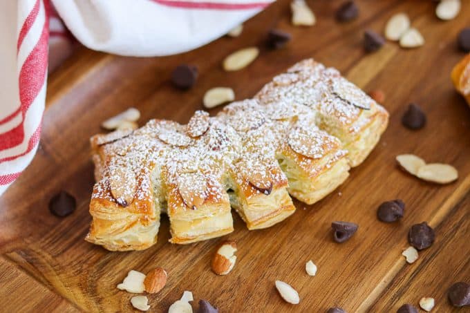 Chocolate Bear Claws - sliced almonds, powdered sugar cover a puff pastry filled with semi-sweet chocolate chips.