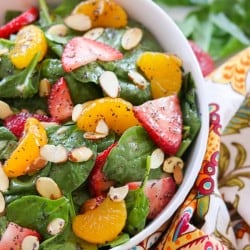Bring summer to your next cookout with this Strawberry Spinach Salad. Filled with fresh spinach, strawberries, mandarin oranges and sliced almond tossed with a sweet and sour dressing, it's sure to be a hit!