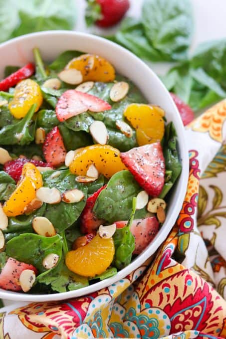Bring summer to your next cookout with this Strawberry Spinach Salad. Filled with fresh spinach, strawberries, mandarin oranges and sliced almond tossed with a sweet and sour dressing, it's sure to be a hit!