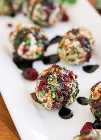 Need the perfect appetizer for a party? Make these Cranberry Pecan Goat Cheese Bites. They're also rolled in fresh parsley.