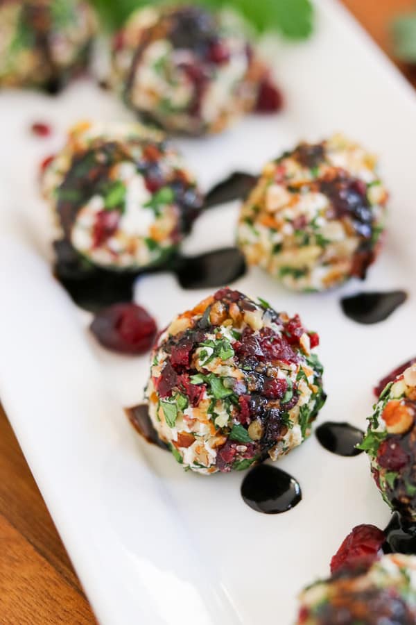 Need the perfect appetizer for a party? Make these Cranberry Pecan Goat Cheese Bites. They're also rolled in fresh parsley.