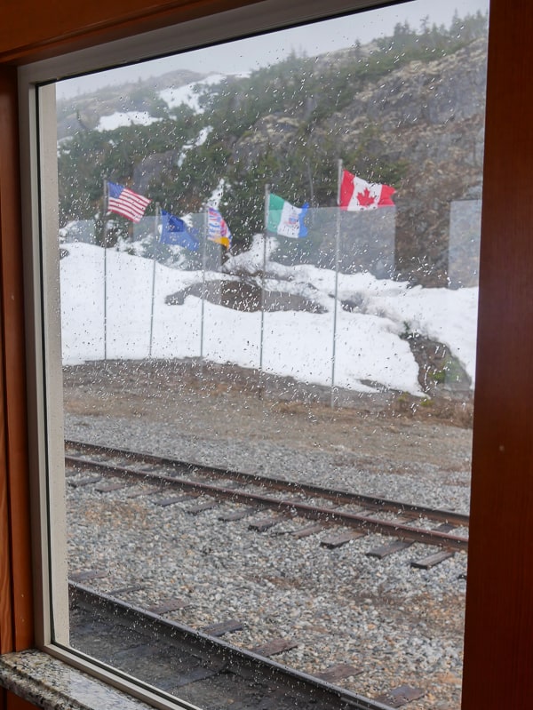 Flags at the US / Canada border on the White Pass Scenic Railway tour.