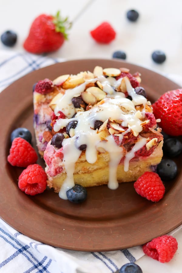 A slice of Almond Berry French Toast Casserole drizzled with Waffle Sauce. THE perfect breakfast!