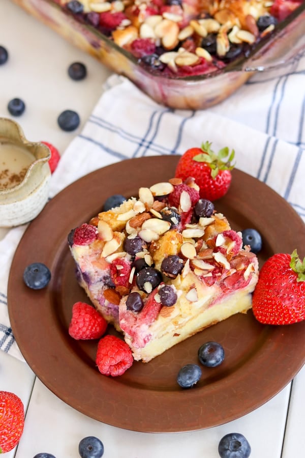 A plate of Almond Berry French Toast Casserole with a side of Waffle Sauce.